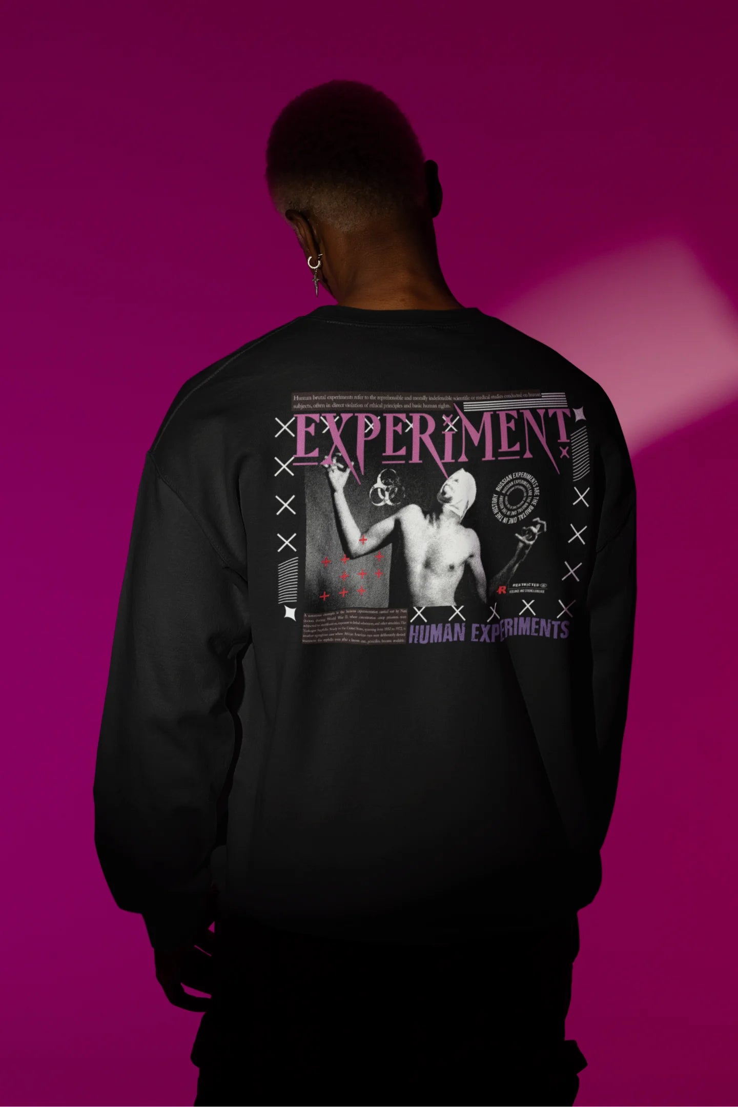 Second back view of a male model wearing a black brutalist sweatshirt with a stylized, concrete-like image of an abstract statue and the word "Experiment" prominently displayed.