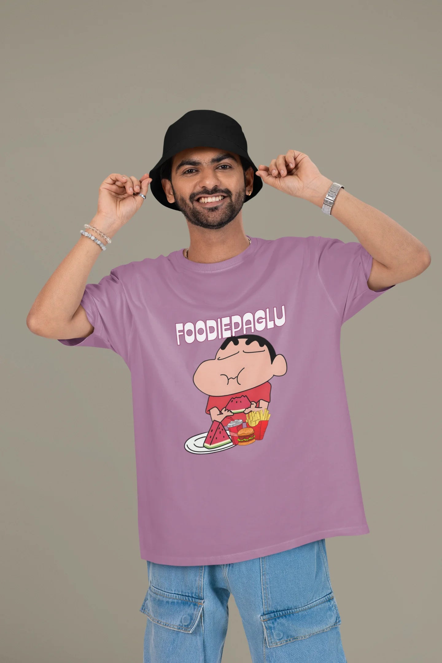 First front of a male view model wearing  a dirty purple oversized t-shirt featuring Shinchan eating a big meal showing his foodie side.