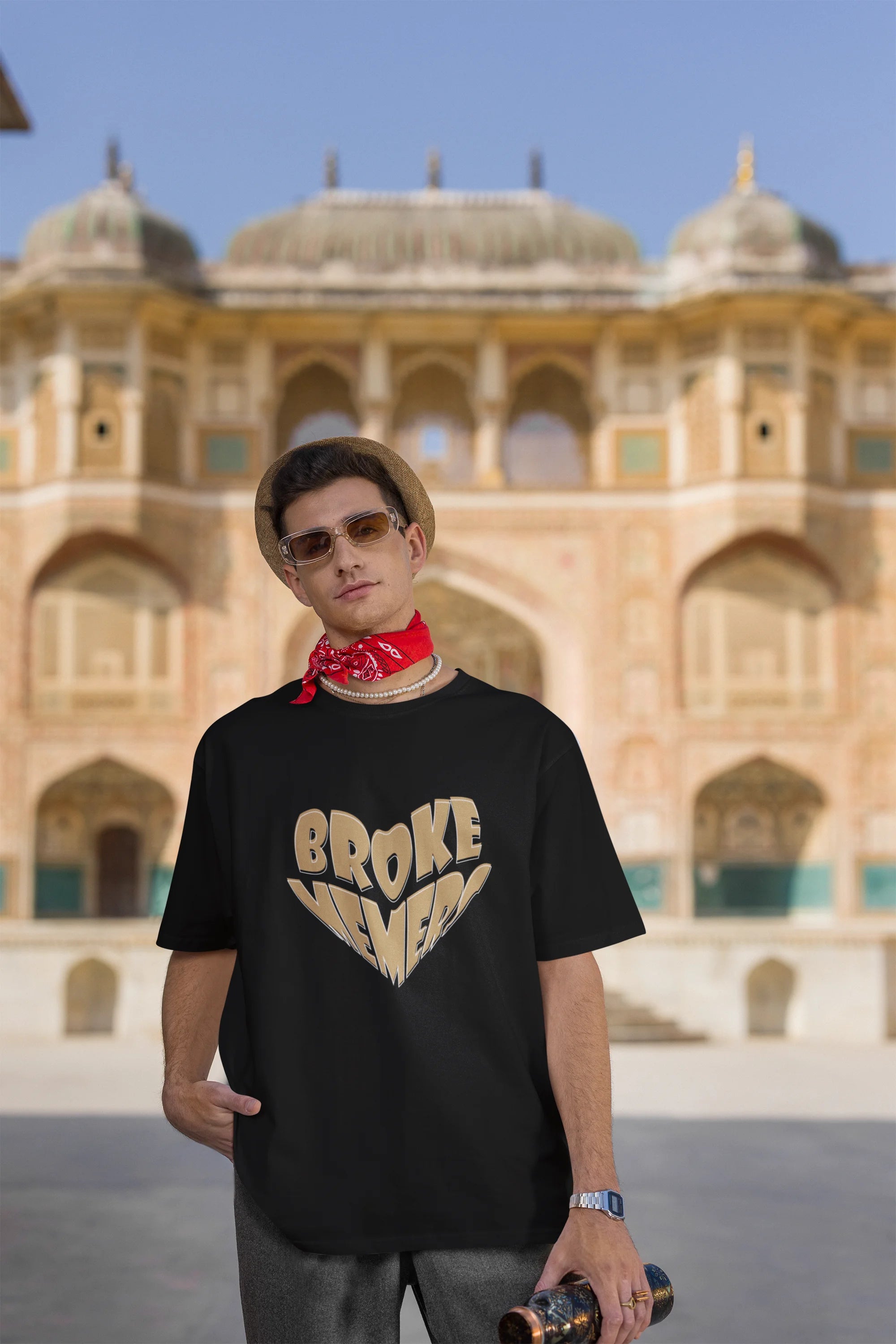 Third front view of female model wearing a black oversized t-shirt featuring the "Broke Memers" logo creatively shaped like a heart. Ideal for fans of Broke Memers who love quality and fashionable clothing.