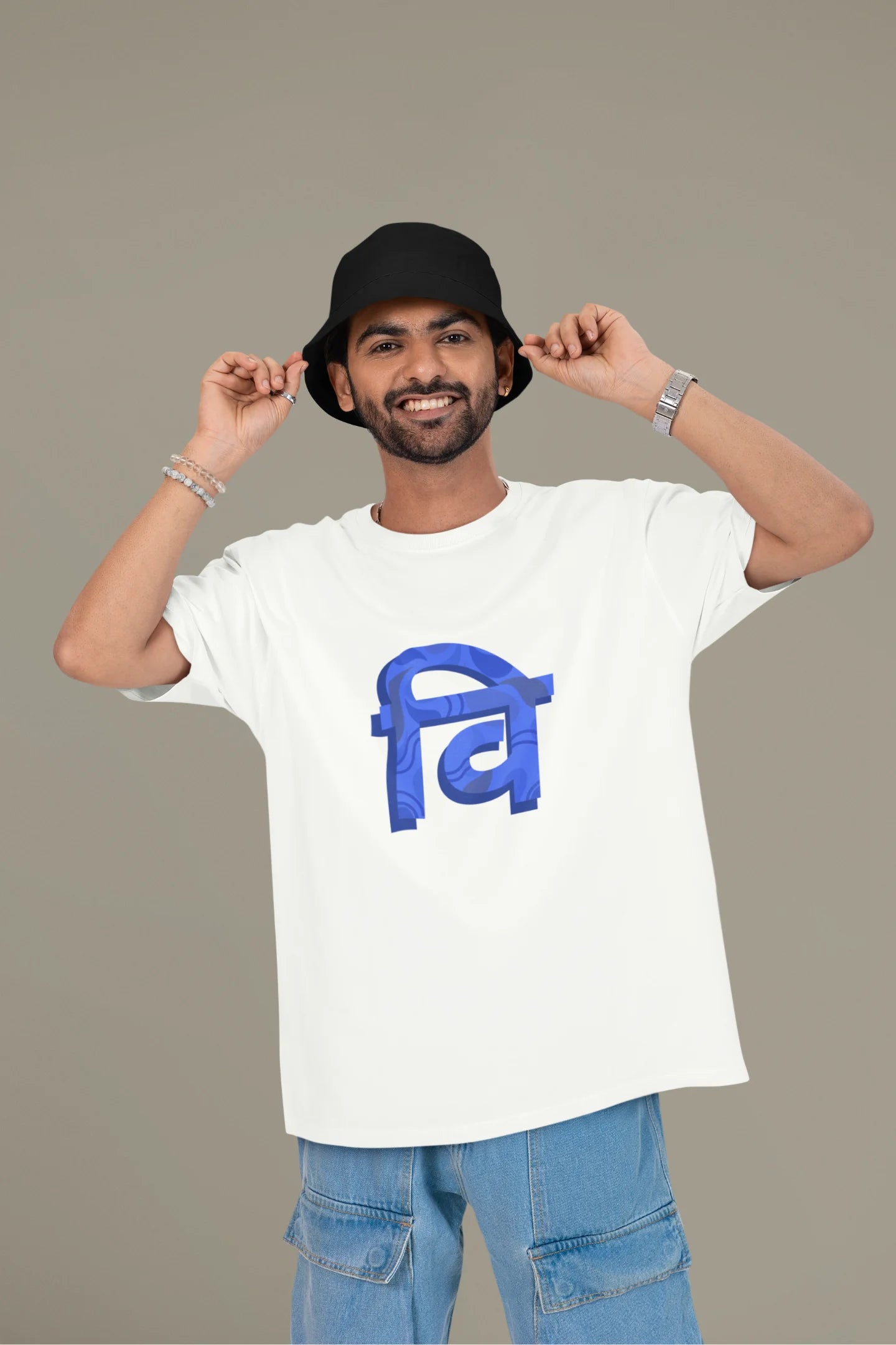 Front view of a male model wearing a white oversized tee with the phrase "Vichitra Pranee" (meaning "Strange being" or "alien") in a stylish Hindi font.