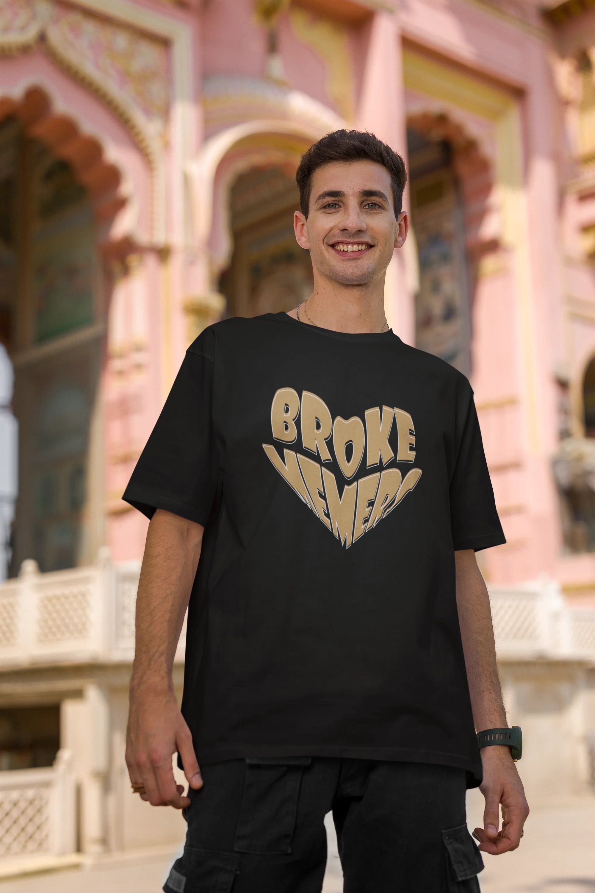 Second front view of female model wearing a black oversized t-shirt featuring the "Broke Memers" logo creatively shaped like a heart. Ideal for fans of Broke Memers who love quality and fashionable clothing.