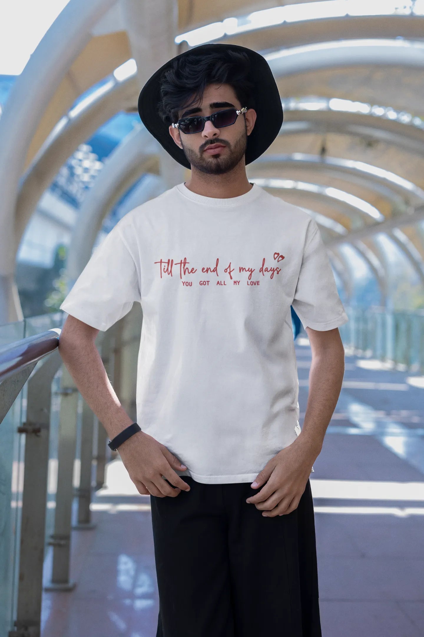 Second front view of a male model wearing a off-white oversized t-shirt with a heart design and the text "All My Love".