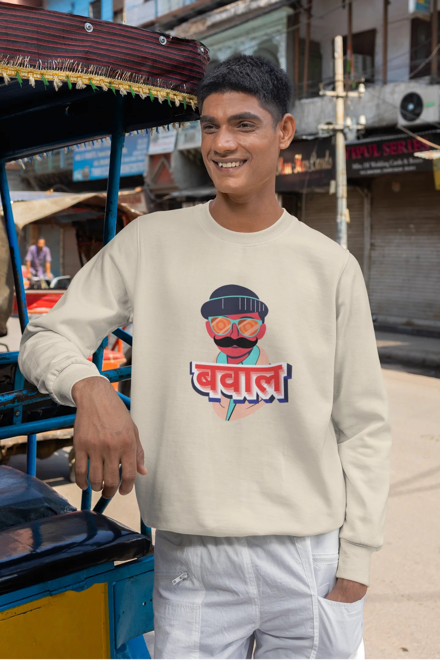 2nd front view of a male model wearing a cream oversized t-shirt with "Bawaal" in a stylish Hindi.