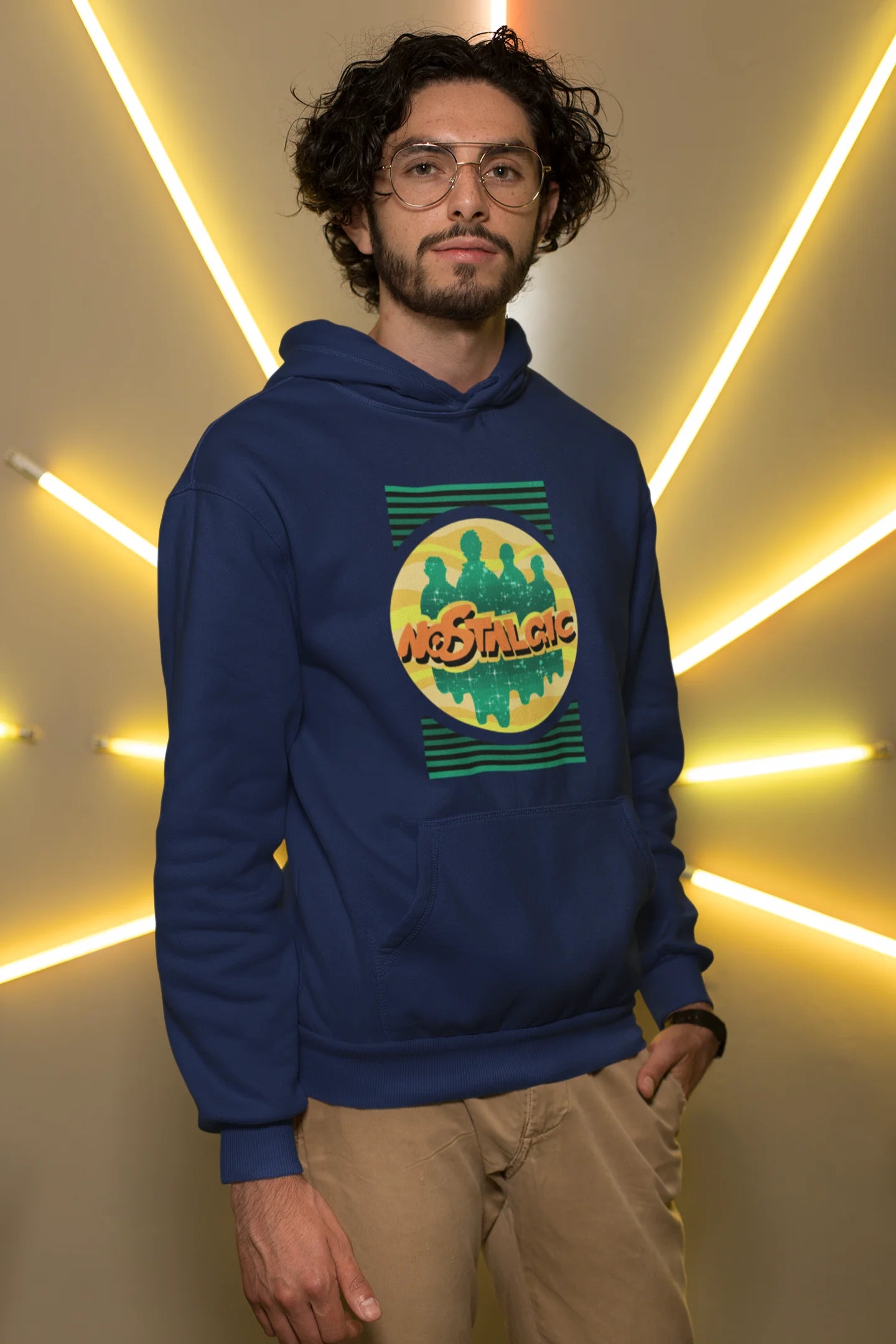 3rd front view of a male model wearing an navy blue hoodie with a shadow silhouette of the Coldplay band members and the word "Nostalgic" printed on it.
