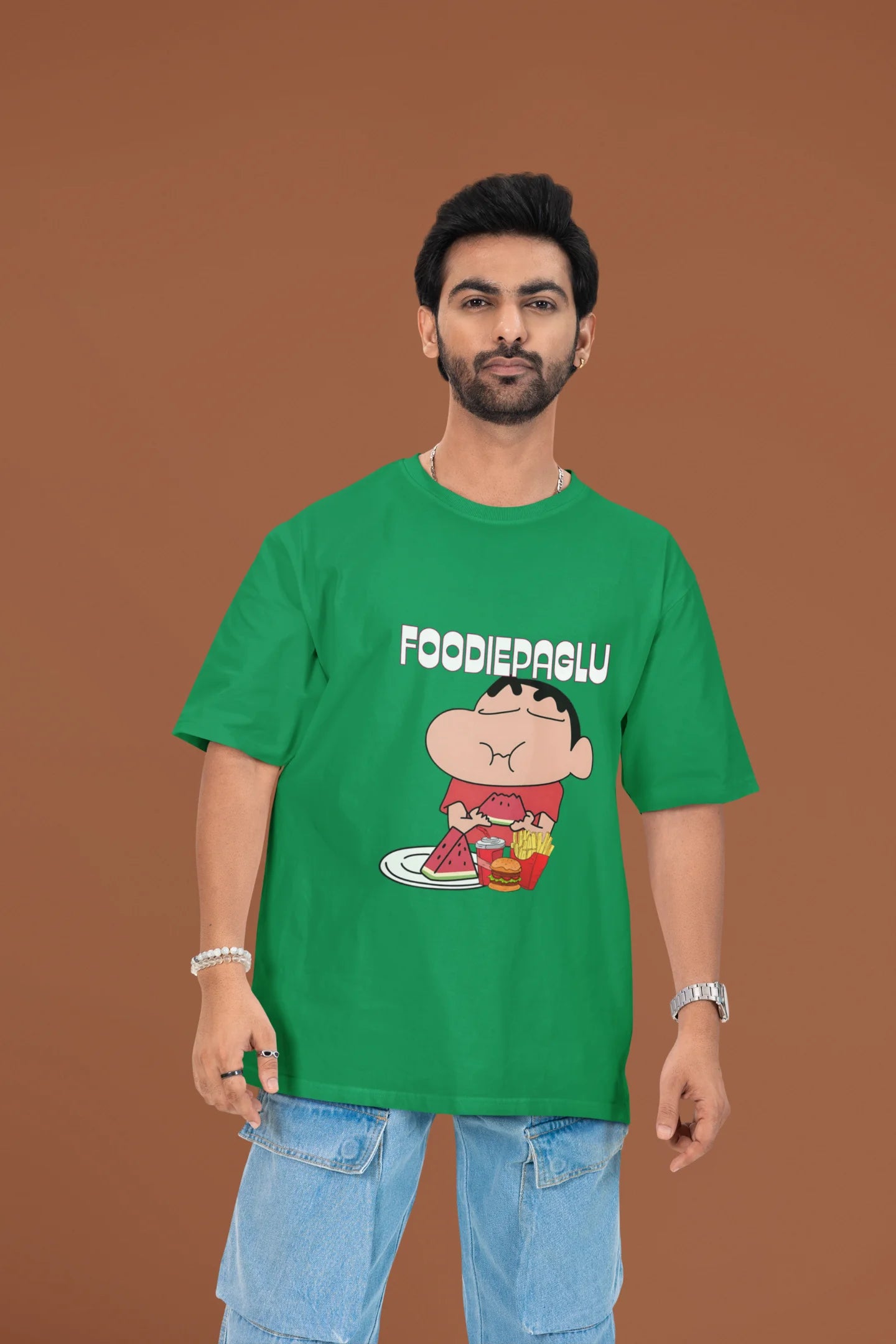2nd front of a male view model wearing  a forest green oversized t-shirt featuring Shinchan eating a big meal showing his foodie side.