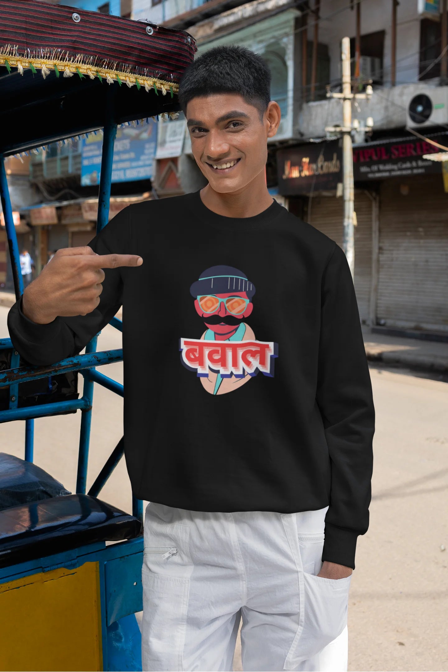 5th front view of a male model wearing a black oversized t-shirt with "Bawaal" in a stylish Hindi.