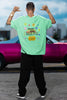 Back view of a male model wearing an oversized mint green t-shirt with a positive message 