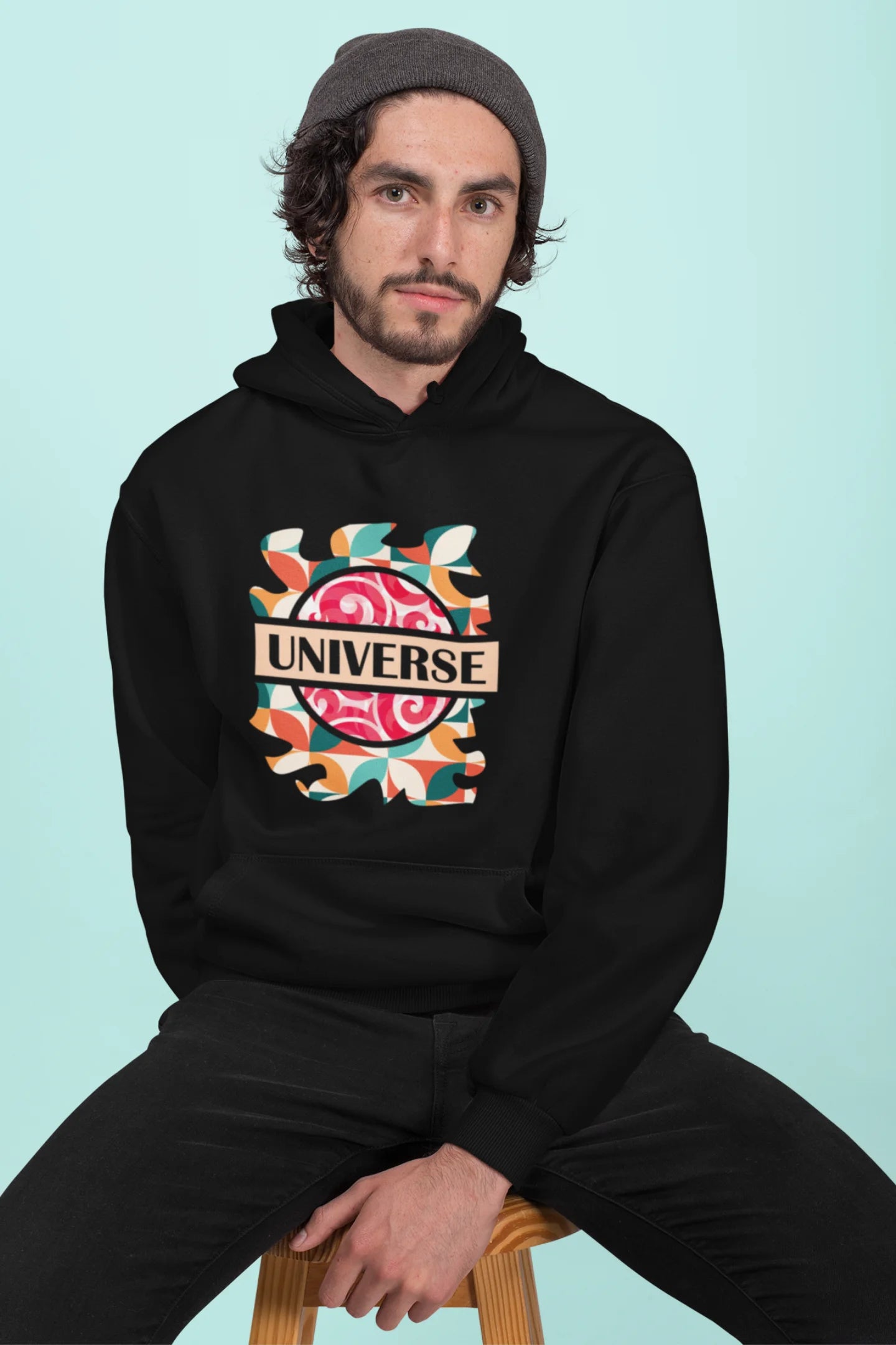 3rd front view of a male model wearing an black hoodie with a cosmic Universe design inspired by Coldplay.
