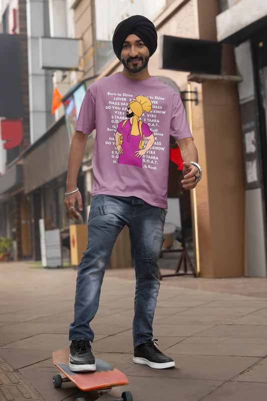 Second image of a male model wearing a dirty purple oversized t-shirt with a Diljit Dosanjh portrait on a t-shirt with his album titles written in the background.