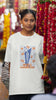 Third front image of female model wearing an off-white oversized t-shirt featuring the World Cup 2024 trophy with the text 