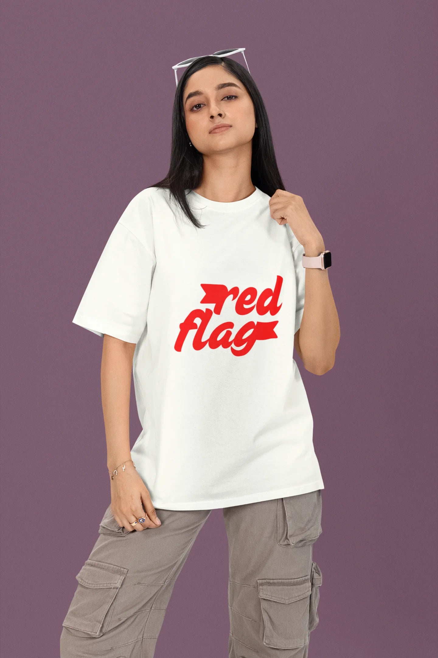 2nd front view of a female model wearing an off-white oversized t-shirt with the text "Red Flag" printed on it.