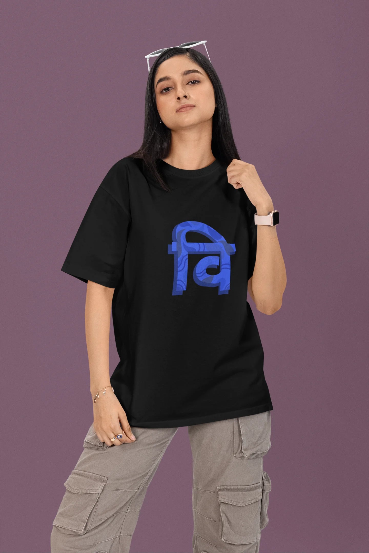 Front view of a female model wearing a black oversized tee with the phrase "Vichitra Pranee" (meaning "Strange being" or "alien") in a stylish Hindi font.