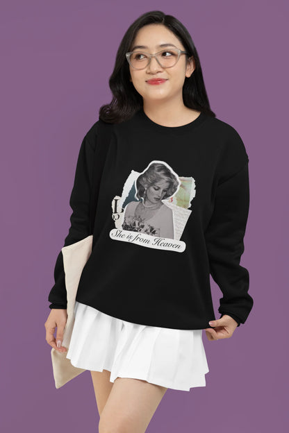 2nd front view of female model wearing a black sweatshirt featuring a black and white photo of Princess Diana with the text "She is from Heaven." Ideal for fans of Princess Diana and those who want to celebrate a royal icon.
