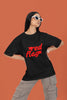 First front view of a female model wearing an black oversized t-shirt with the text 