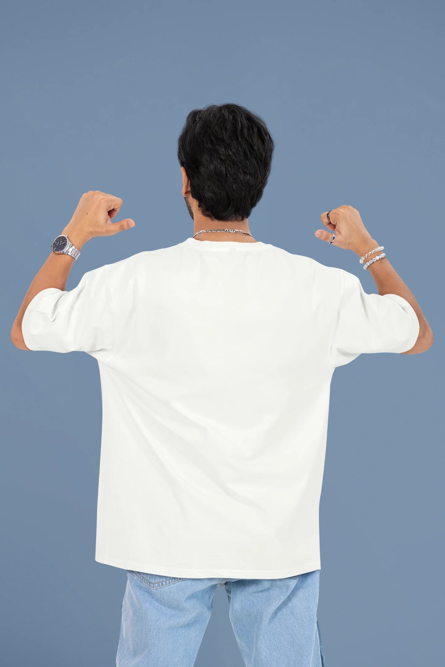 Back view of a male model wearing an off-white oversized t-shirt with the text "Red Flag" printed on it.