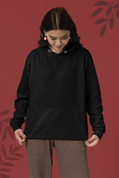 Second front view of a female model wearing a black hoodie with a design of a wildcat sitting on ocean waves.