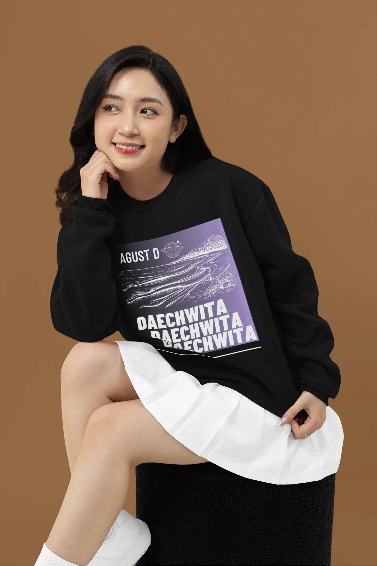 Second front view of a female model wearing a black sweatshirt featuring a bold design inspired by BTS member Suga's alter ego, August D. Ideal for BTS fans (ARMY) and K-Pop enthusiasts who love rap music and artist individuality.