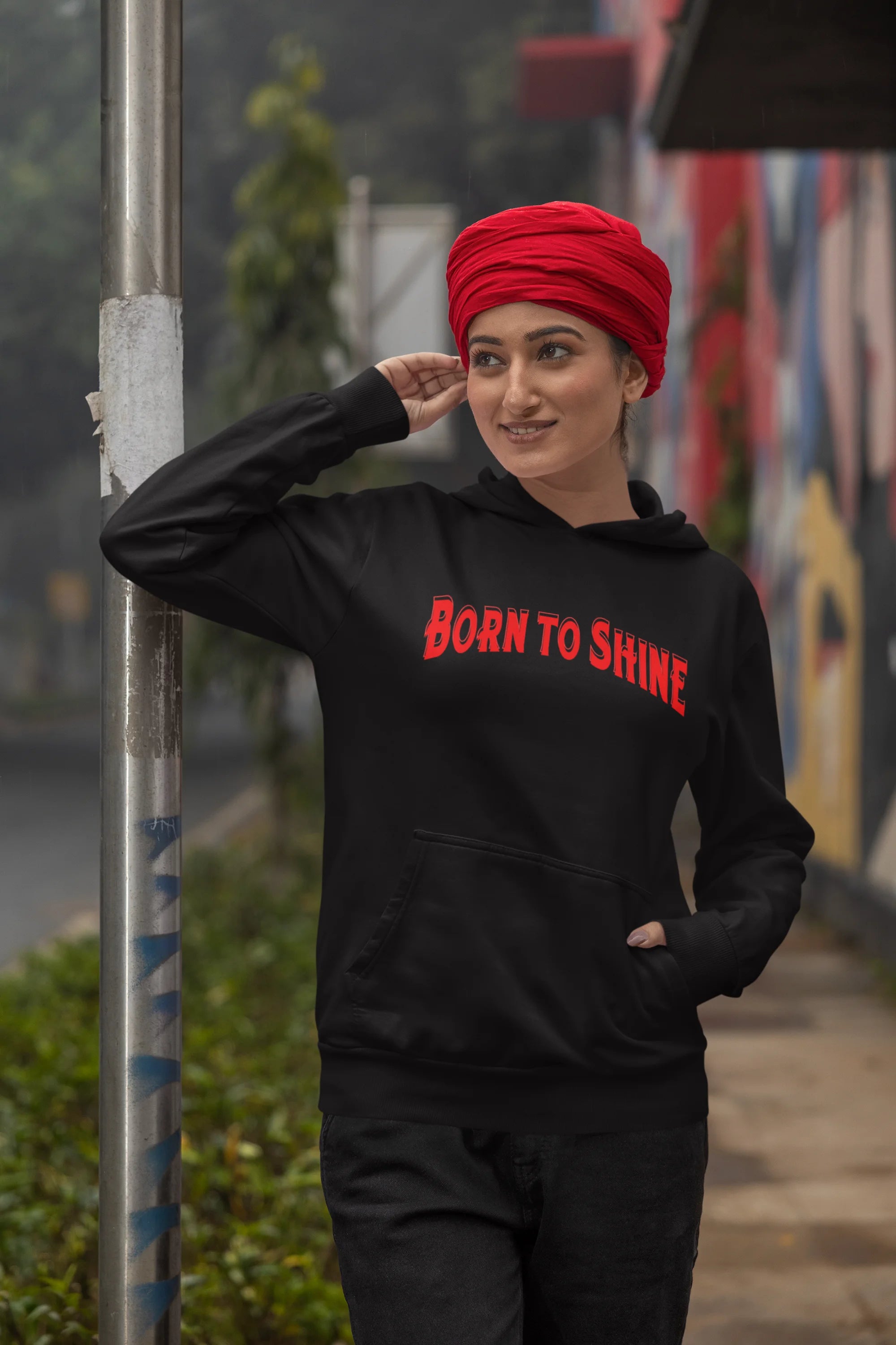 Third image of a female model wearing a black Diljit Dosanjh hoodie with the text "Born to Shine."