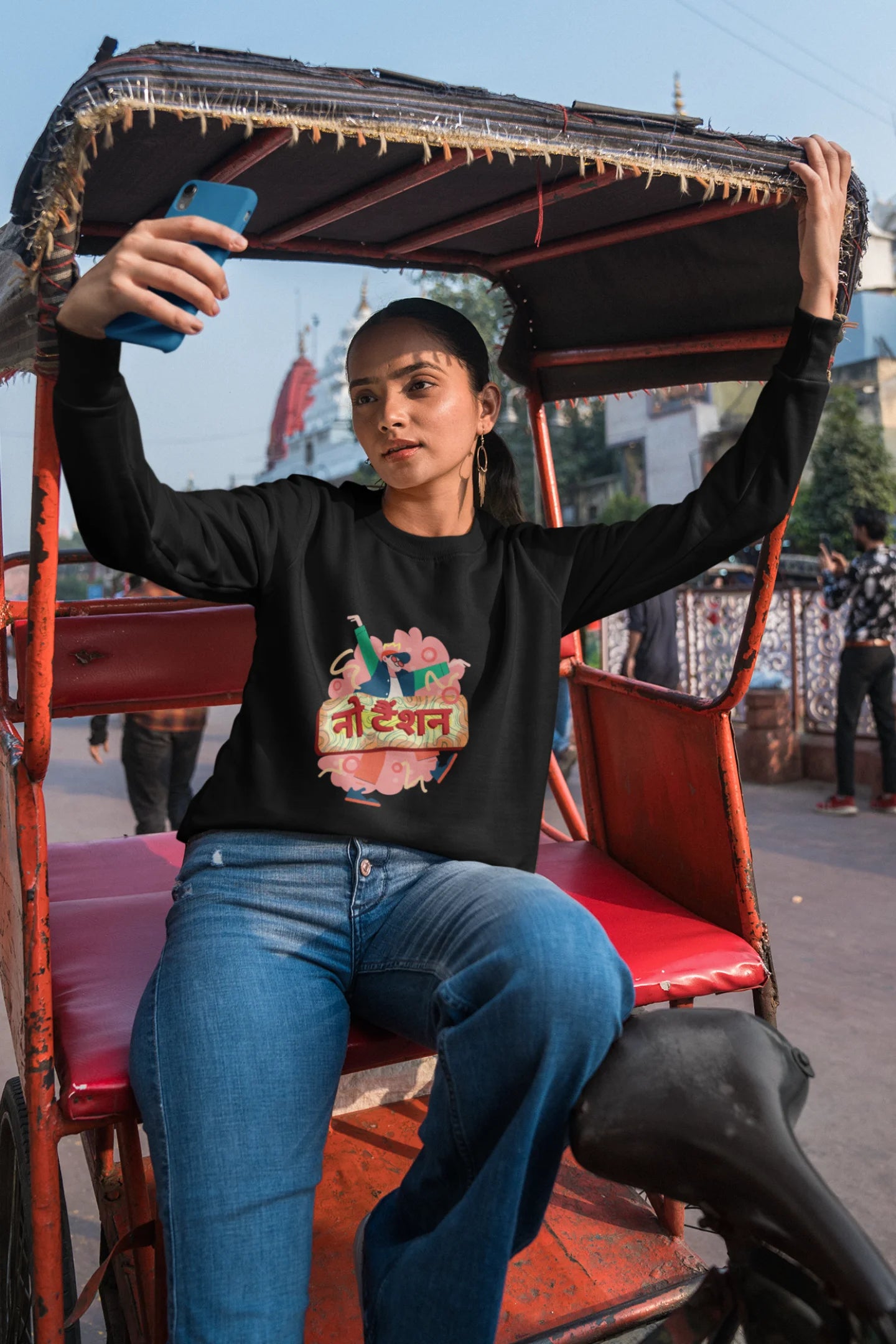 3rd front view of a female model wearing a black oversized t-shirt with the phrase "No Tension" in a relaxed, unique script.