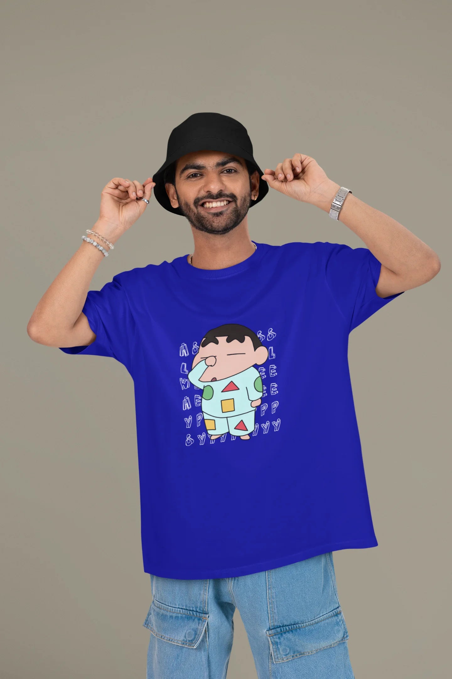 First front view of a male model wearing a royal blue oversized t-shirt featuring  Shinchan looking sleepy.