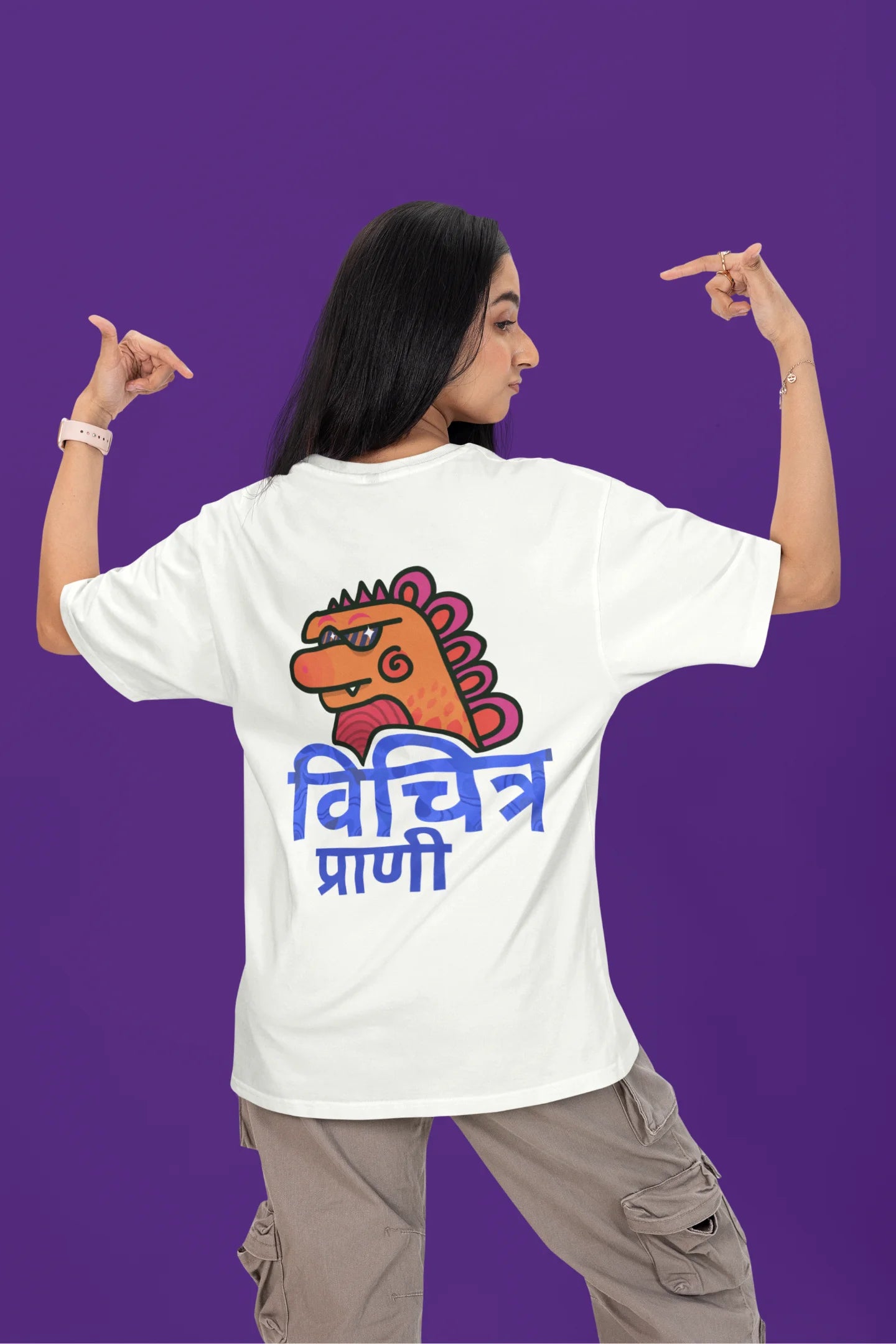 Back view of a female model wearing a white oversized tee with the phrase "Vichitra Pranee" (meaning "Strange being" or "alien") in a stylish Hindi font.