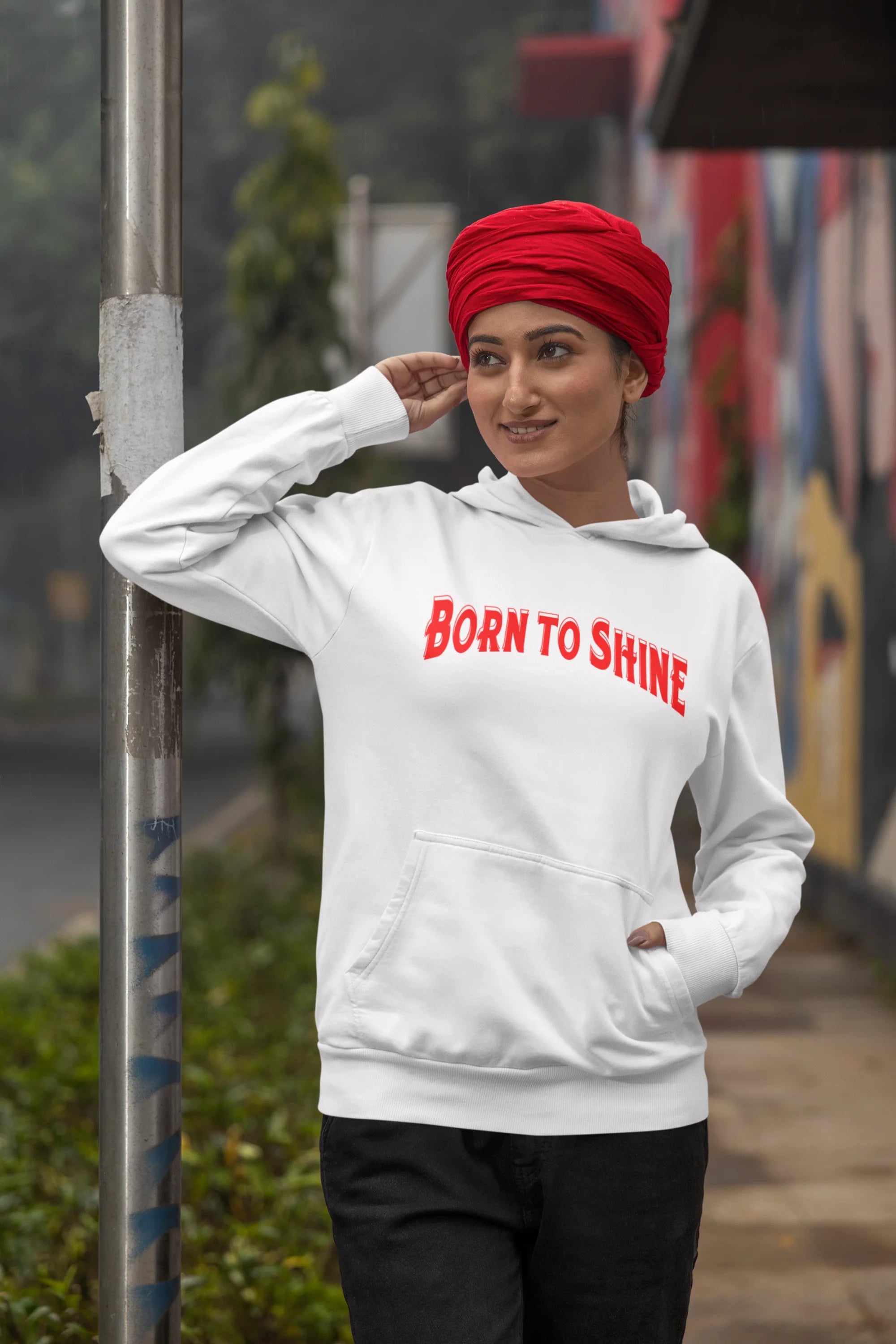 Third image of a female model wearing a off-white Diljit Dosanjh hoodie with the text "Born to Shine."