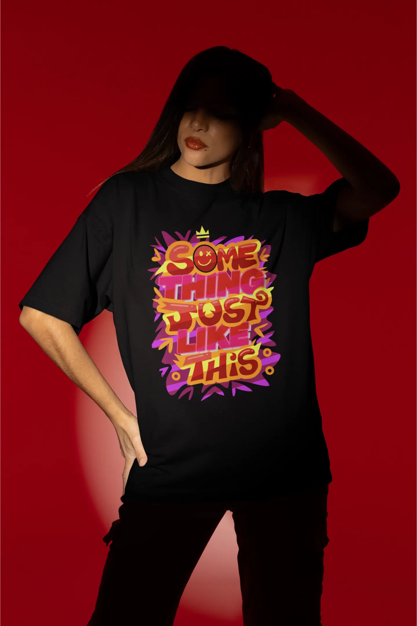 First front view of a female model wearing an black oversized t-shirt featuring the designs inspired from Coldplay's "Something Just Like This" music video.