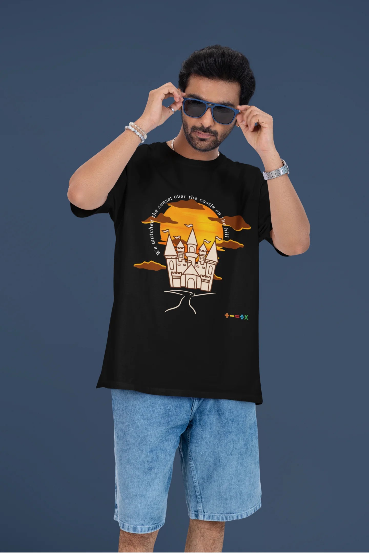 4th front view of a male model wearing a black oversized t-shirt featuring a nostalgic sunset and castle design, related to Ed Sheeran's "Castle on the Hill."