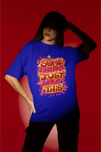 First front view of a female model wearing an royal blue oversized t-shirt featuring the designs inspired from Coldplay's "Something Just Like This" music video.