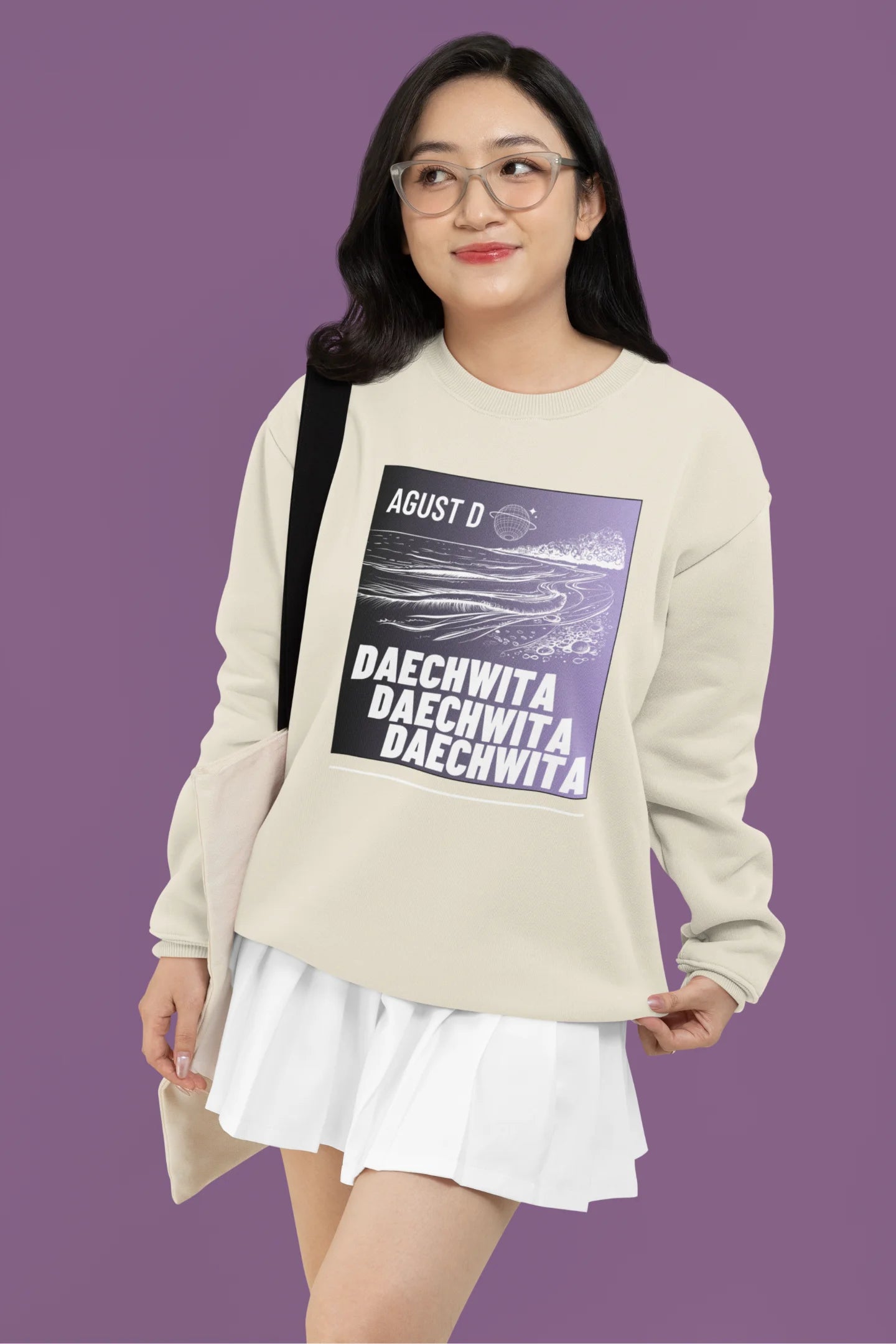 Fourth front view of a female model wearing a cream sweatshirt featuring a bold design inspired by BTS member Suga's alter ego, August D. Ideal for BTS fans (ARMY) and K-Pop enthusiasts who love rap music and artist individuality.