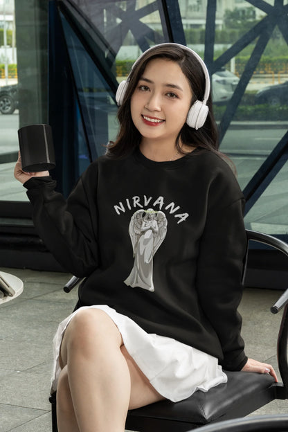 2nd front image of female model wearing a black sweatshirt featuring a design of a winged angel with the text "Nirvana" above it. Ideal for fans of Nirvana and those who love grunge aesthetics.