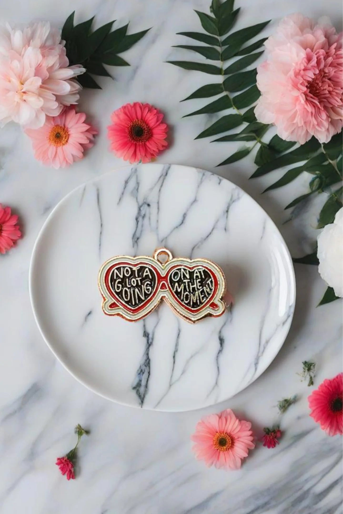 First view of a charm featuring a design inspired by Taylor Swift's "Evermore" album.