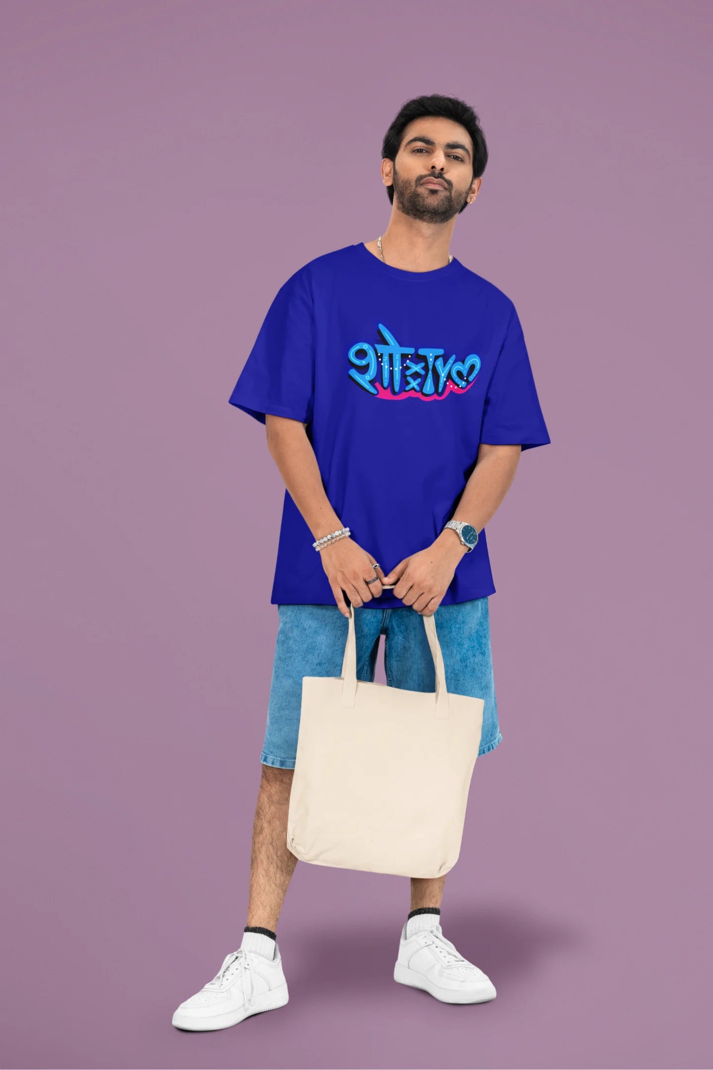 3rd front view of a male model wearing a royal blue oversized t-shirt featuring "Showtime" in Hindi.