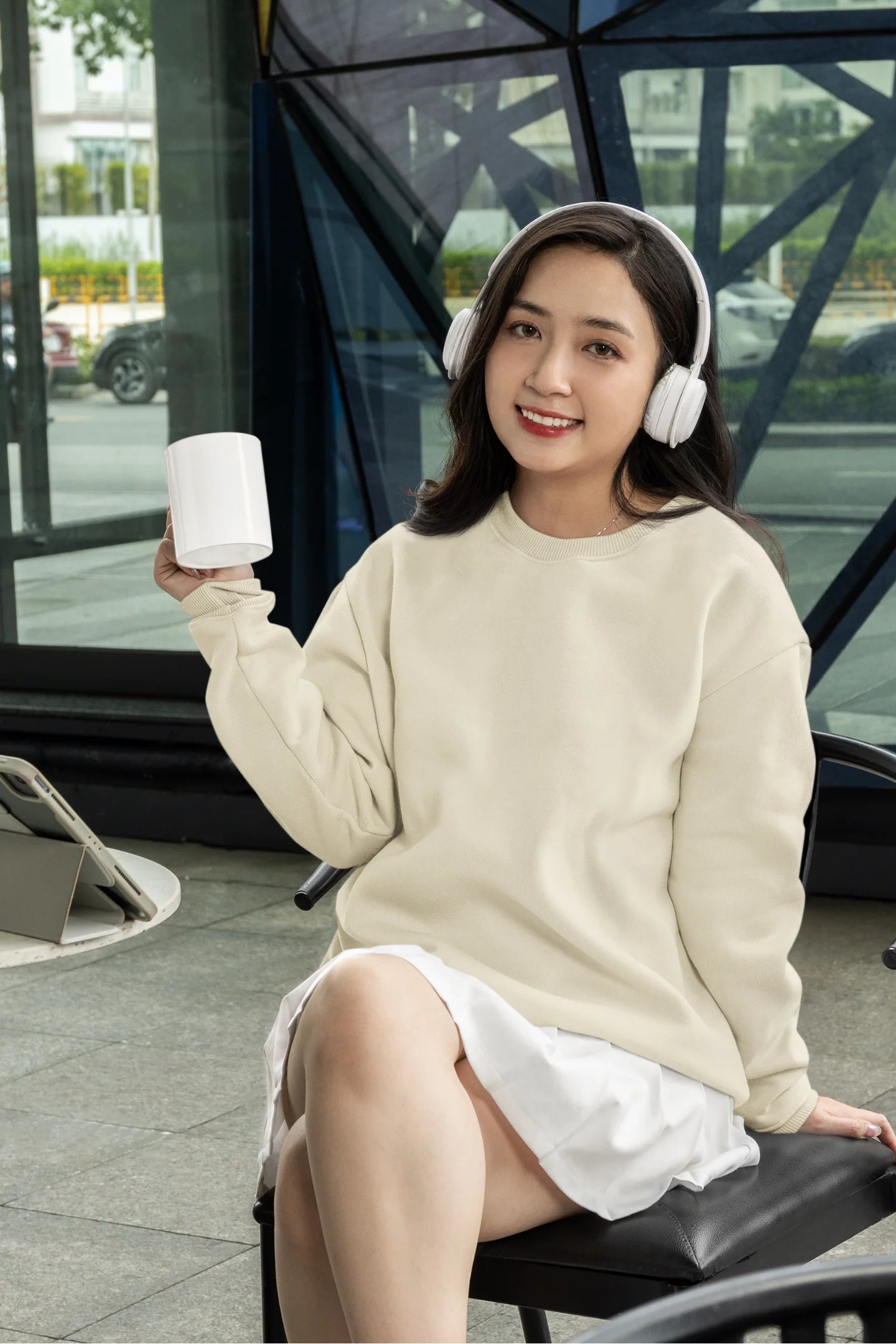 Fourth front view of a female model wearing a off-cream F.R.I.E.N.D.S. sweatshirt featuring a fun design inspired by Phoebe Buffay and her iconic quotes.