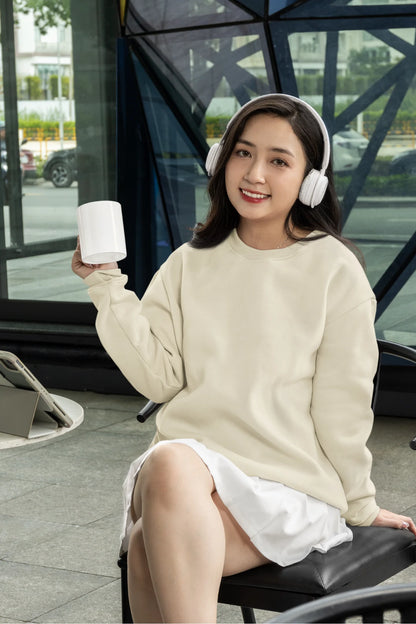 Fourth front view of a female model wearing a off-cream F.R.I.E.N.D.S. sweatshirt featuring a fun design inspired by Phoebe Buffay and her iconic quotes.