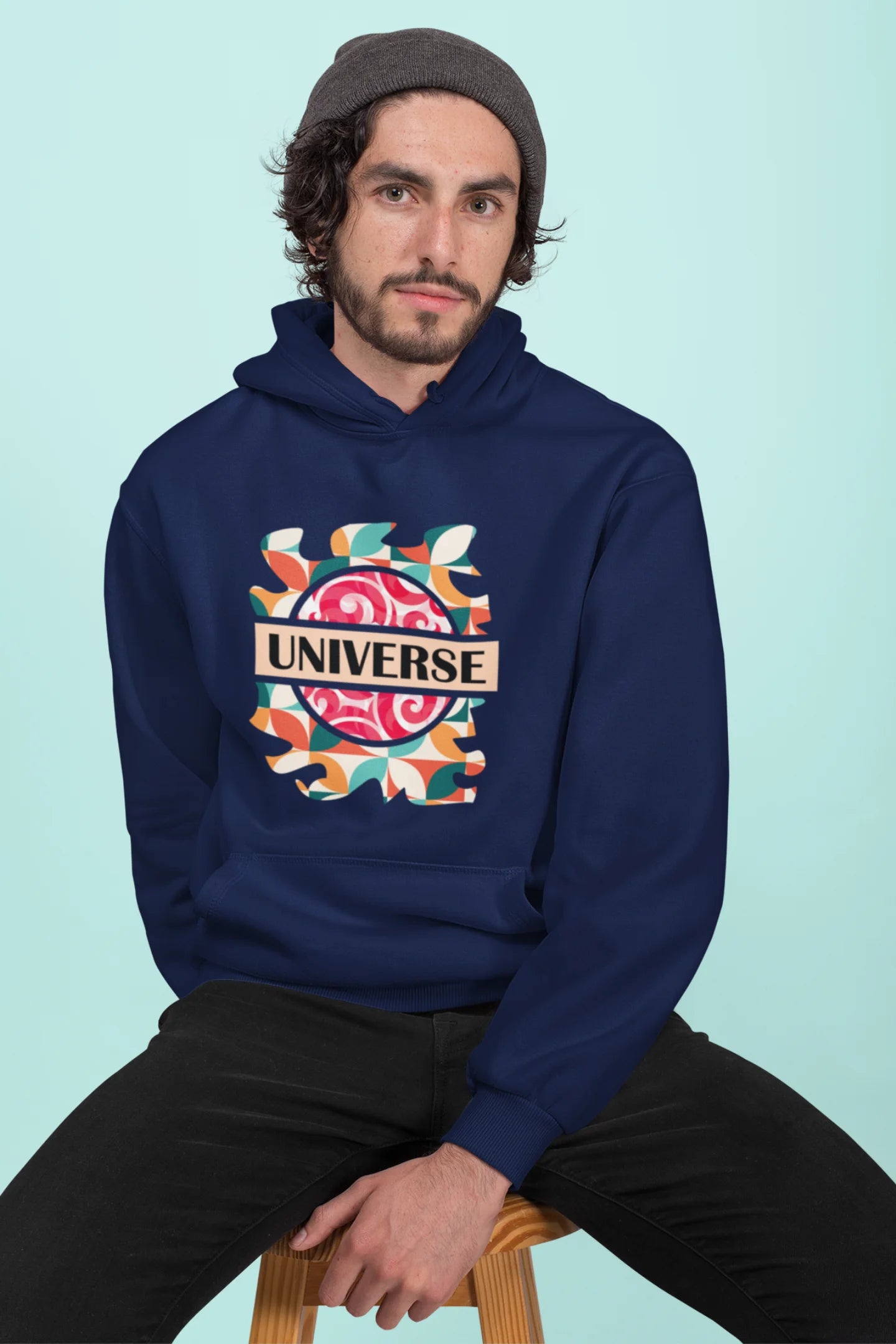 First front view of a male model wearing an royal blue hoodie with a cosmic Universe design inspired by Coldplay.