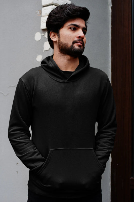 First front view of a male model wearing a black hoodie featuring a Range Rover Defender design, exuding power and ruggedness.