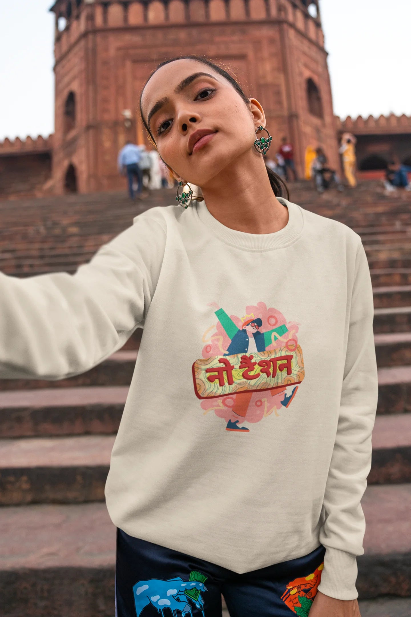 5th front view of a female model wearing a cream oversized t-shirt with the phrase "No Tension" in a relaxed, unique script.