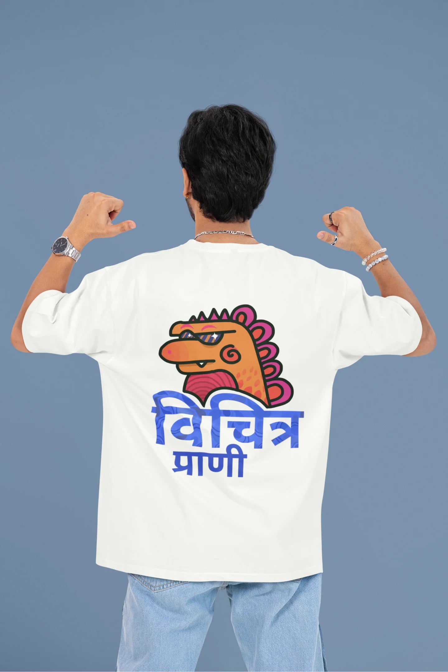 Back view of a male model wearing a white oversized tee with the phrase "Vichitra Pranee" (meaning "Strange being" or "alien") in a stylish Hindi font.