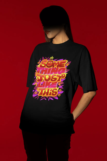 Second front view of a female model wearing an black oversized t-shirt featuring the designs inspired from Coldplay's "Something Just Like This" music video.