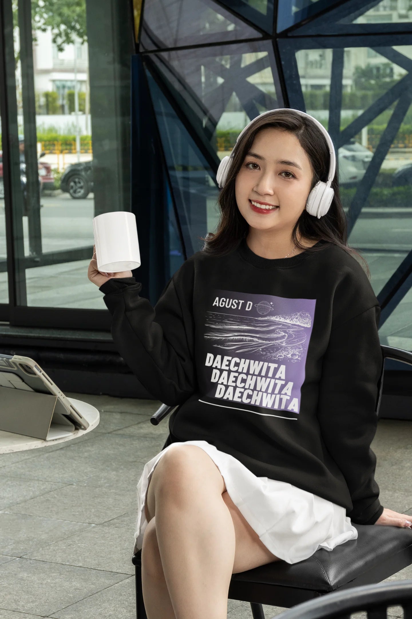 Fourth front view of a female model wearing a black sweatshirt featuring a bold design inspired by BTS member Suga's alter ego, August D. Ideal for BTS fans (ARMY) and K-Pop enthusiasts who love rap music and artist individuality.