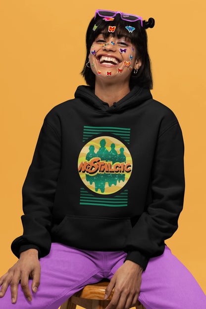 2nd front view of a female model wearing an black hoodie with a shadow silhouette of the Coldplay band members and the word "Nostalgic" printed on it.