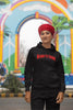 First image of a female model wearing a black Diljit Dosanjh hoodie with the text 