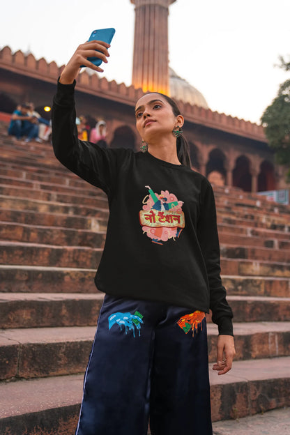 2nd front view of a female model wearing a black oversized t-shirt with the phrase "No Tension" in a relaxed, unique script.