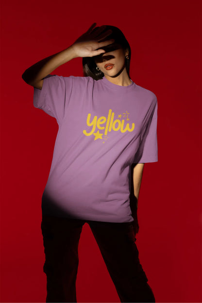 Third front view of a female model wearing a dirty purple oversized t-shirt with the "Yellow" album artwork by Coldplay.