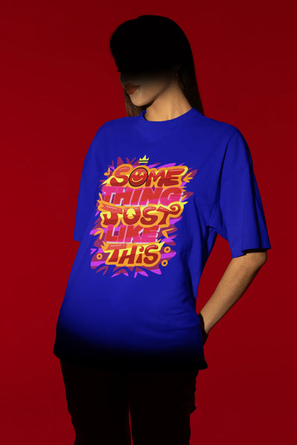 Second front view of a female model wearing an royal blue oversized t-shirt featuring the designs inspired from Coldplay's "Something Just Like This" music video.
