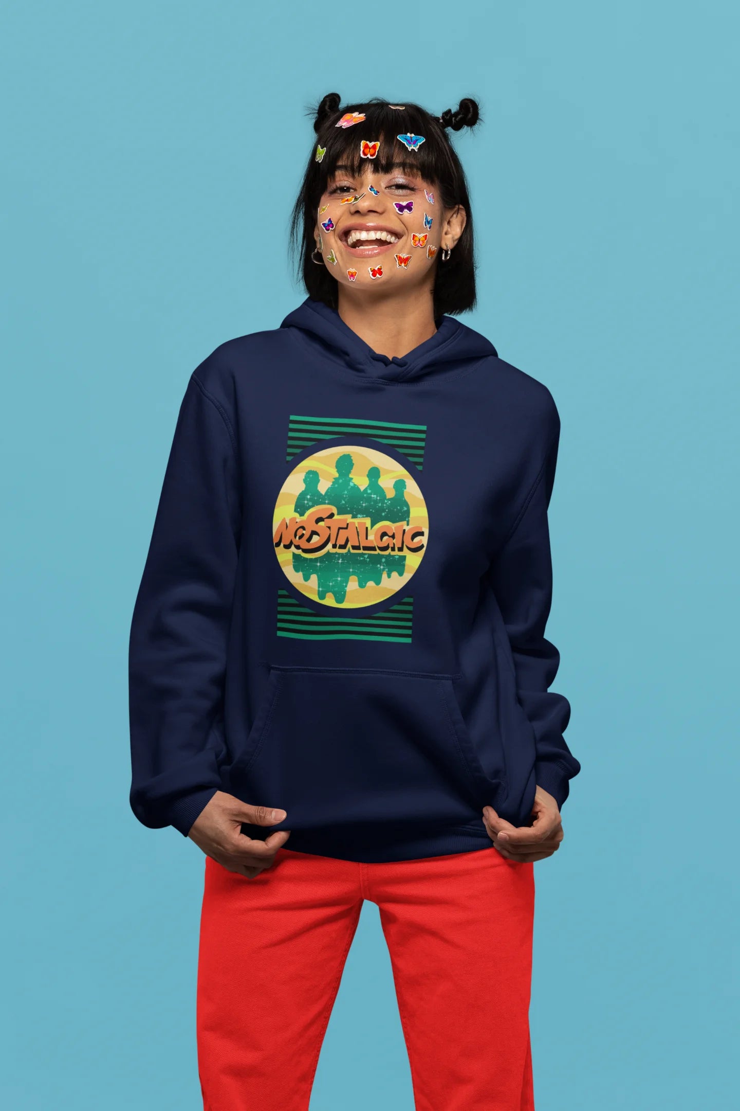 4th front view of a female model wearing an navy blue hoodie with a shadow silhouette of the Coldplay band members and the word "Nostalgic" printed on it.