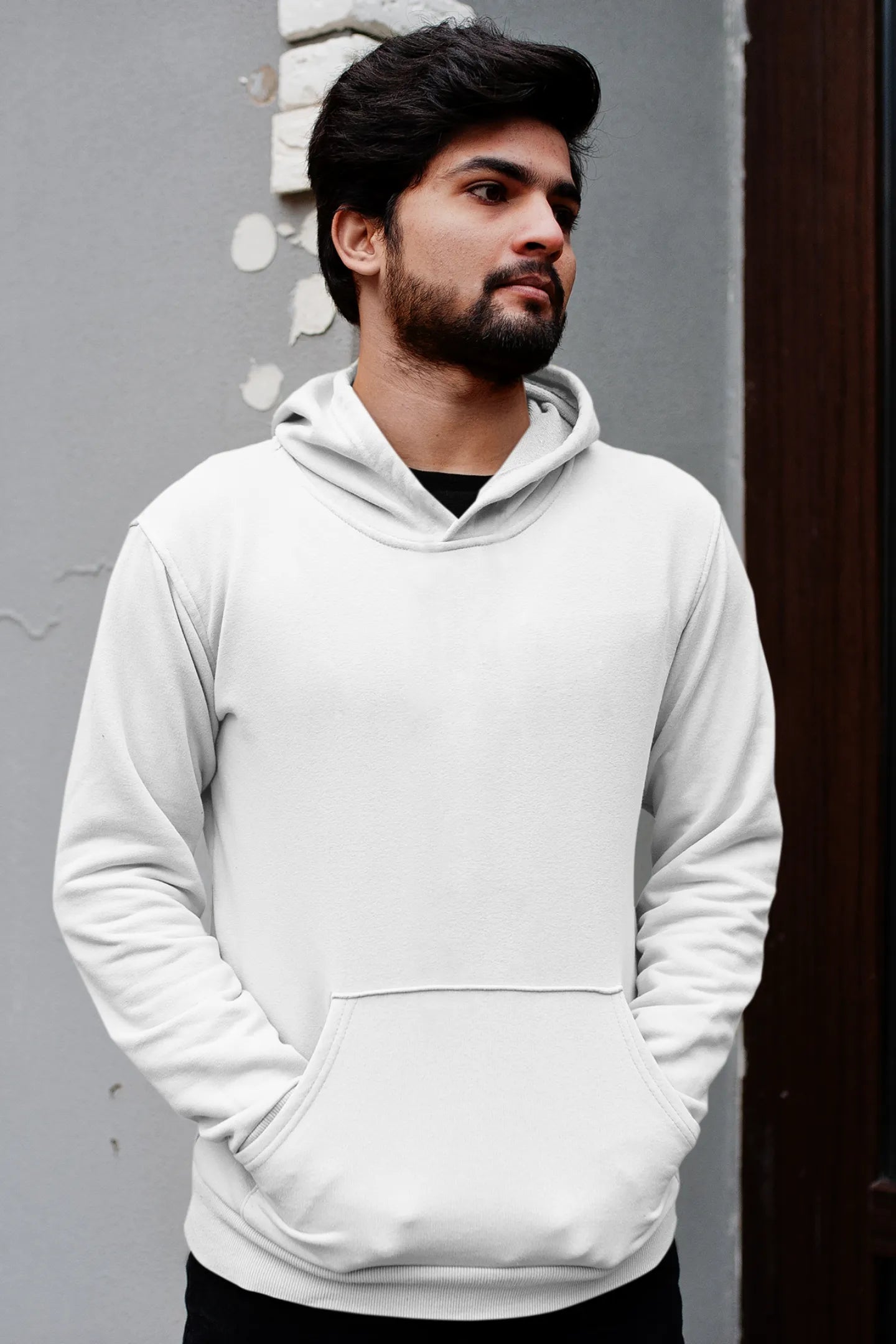 Third front view of a male model wearing a white hoodie with a panda fox surrounded by bamboo.