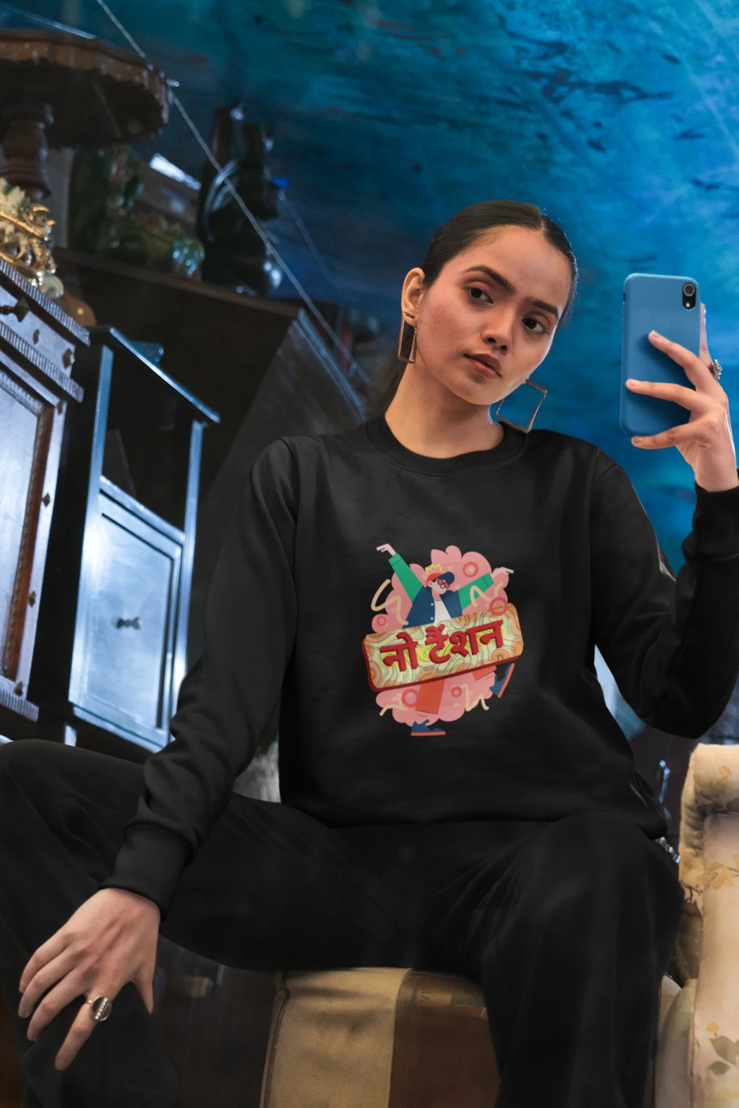 6th front view of a female model wearing a black oversized t-shirt with the phrase "No Tension" in a relaxed, unique script.