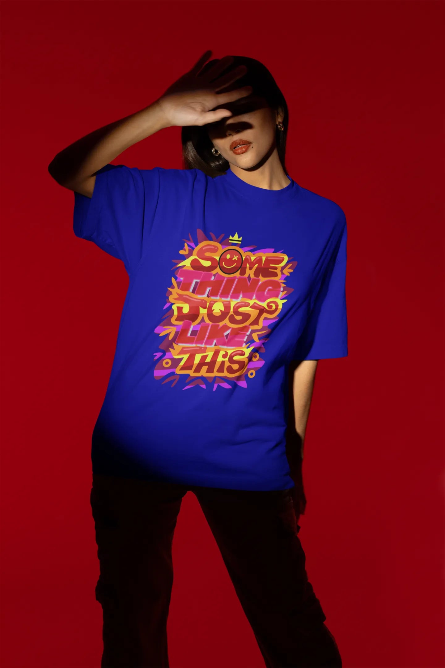 Fourth front view of a female model wearing an royal blue oversized t-shirt featuring the designs inspired from Coldplay's "Something Just Like This" music video.